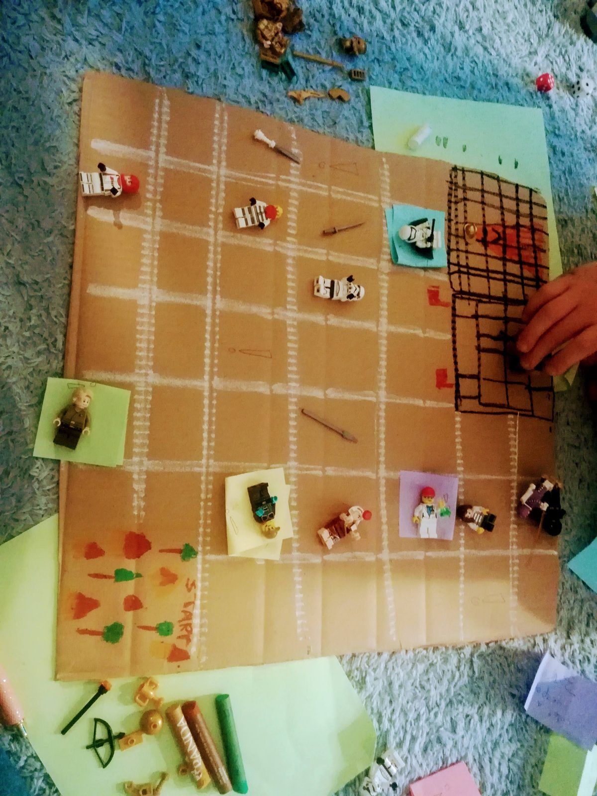 A student-built board game laid out on the floor