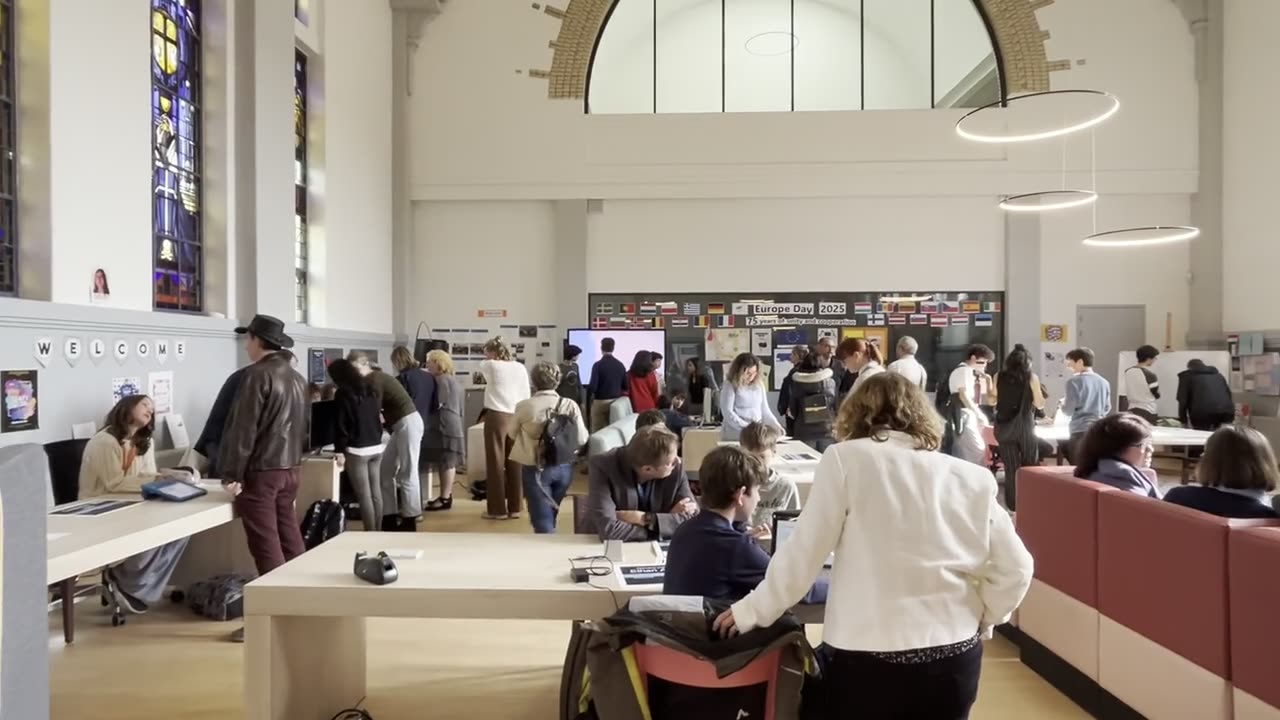 Families and teachers walking through a Limitless showcase event of student work